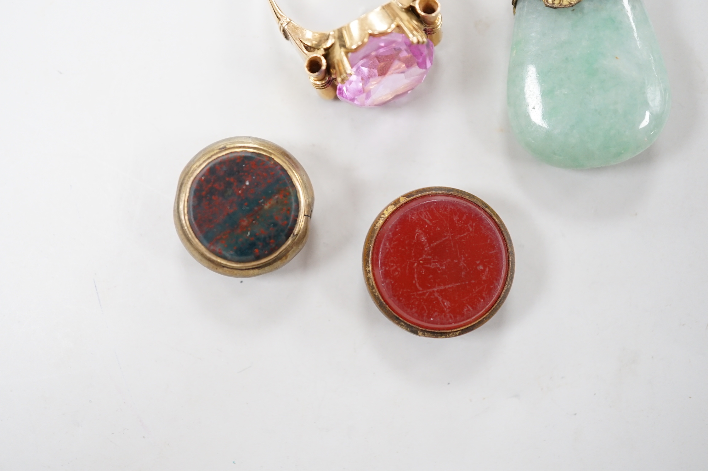 Two damaged carnelian set fobs and two other items including a yellow metal and pink stone ring.